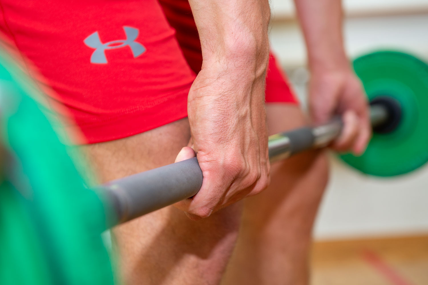 Close-up of a barbell held by two hands.